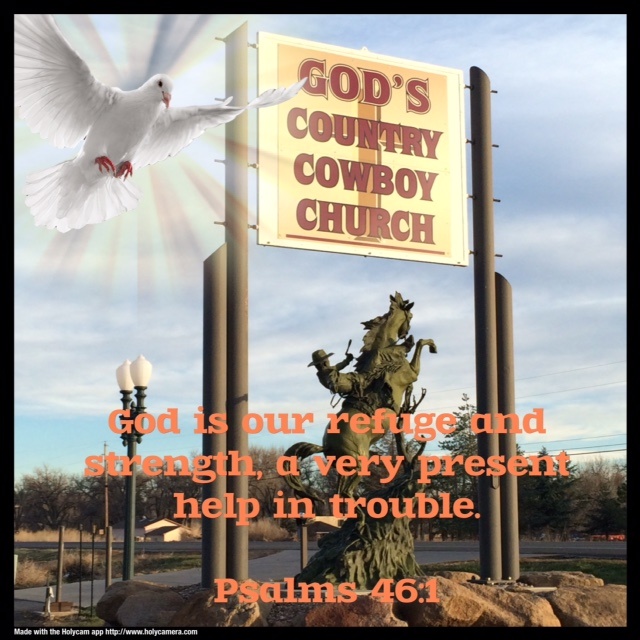 God's Country Cowboy Church sign with bucking bronco statue below it