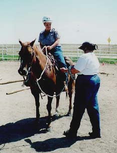 Kim doing a leg release on a student rider.